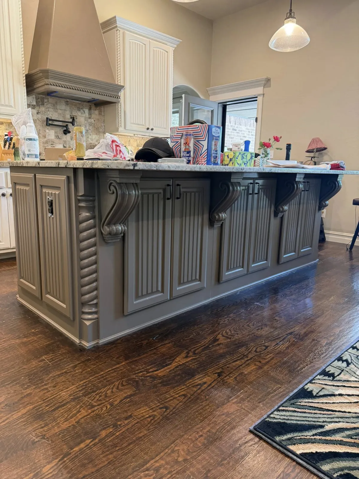 The same kitchen island and cabinets refinished in gray