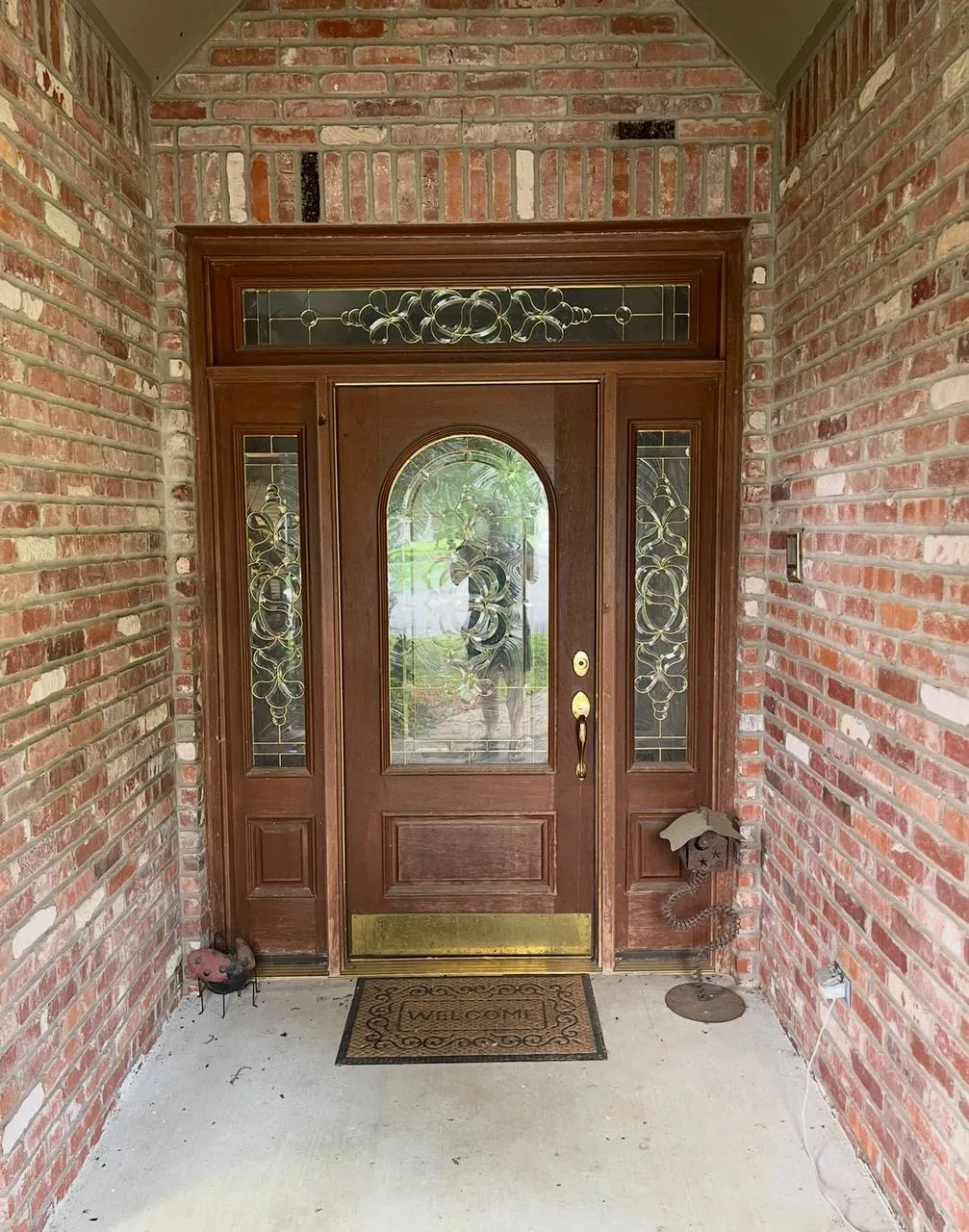 Wood entry door and brick surround before refinishing